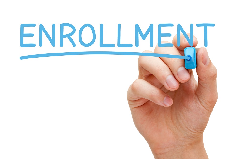 hand with enrollment written in marker